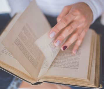 Person Paging Through Bible